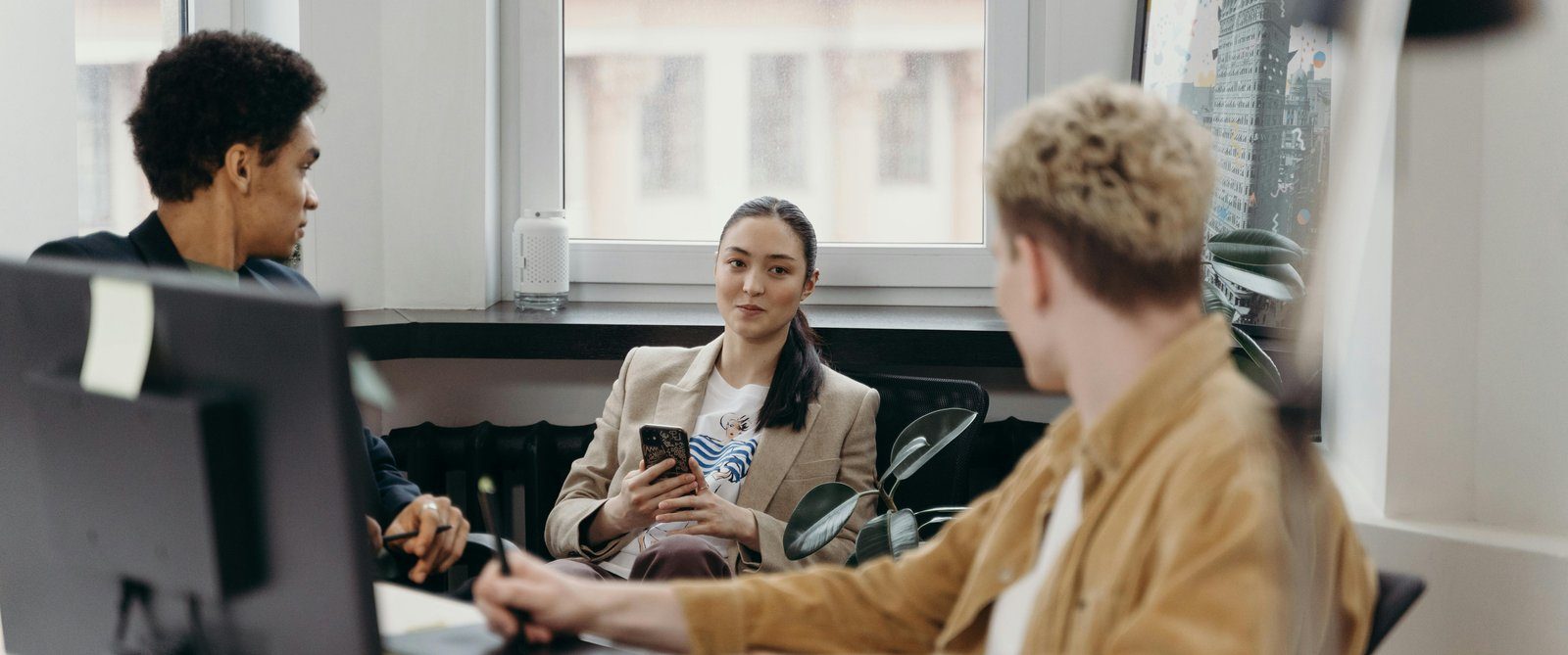 Colleagues talking at an office desk